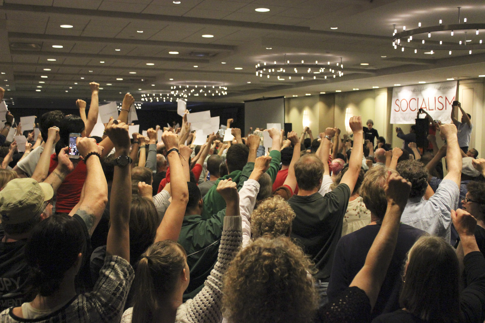 Socialists at conference with fists up.